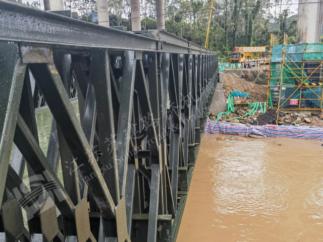 Modular Bailey bridge installed in flood area for rapid river crossing