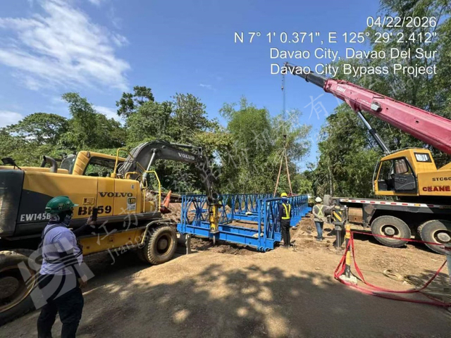 Crane lifting modular steel bridge components for a Philippine highway project