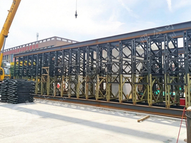 Long prefabricated steel truss bridge installed for construction access