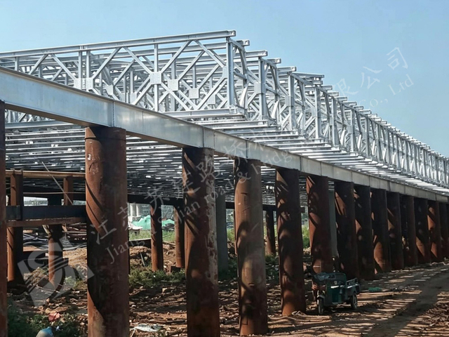 Completed modular steel truss bridge for a temporary river crossing