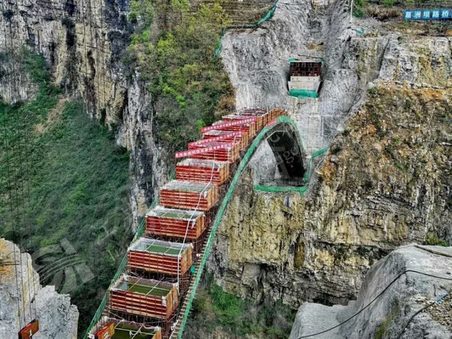 Prefabricated steel arch bridge segments installed across the Xixi River gorge